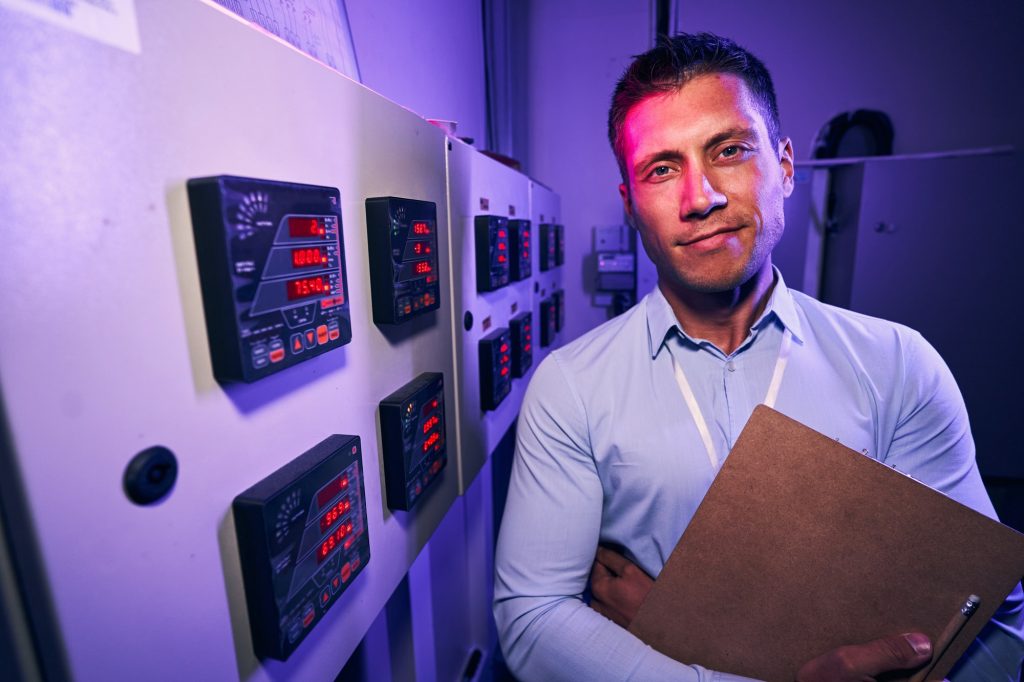 Pleased Caucasian male employee in data center