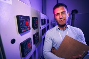 Pleased Caucasian male employee in data center